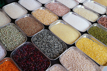 A set of various cereals, peas, rice in metal bowls.