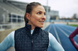 © Flamingo Images - Woman smiling before a run on a track