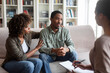 © Prostock-studio - Loving black woman embracing her depressed husband, therapy session