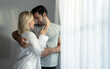 © Basicdog - Beautiful young couple warmly embrace in the bedroom.