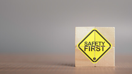 Wall Mural - Work safety concept. Safety first text yellow in wooden cube and copy spec. Safety first sign on virtual screen. Hazards, protections, regulations and insurance, Zero accidents, Protection dangerous.