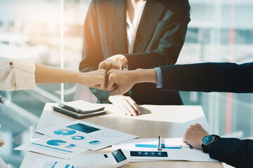 Group of business people putting their hands working together on wooden background in office. group support teamwork agreement concept.