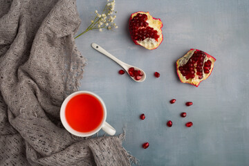 Wall Mural - Red juice pomegranate composition on green background