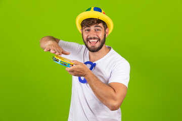 Wall Mural - Young boy dressed for carnival with a tambourine in his hands. Young man dressed in carnival costume playing tambourine at carnival party