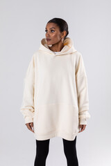 Wall Mural - Attractive african american woman in oversized white hoodie. Mock-up.
