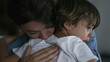 © Marco - Mother hugging and caressing child back. Parent consoles crying small boy. Motherhood love and affection concept