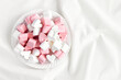 Pink and white marshmallows heart shape. Fluffy sweets for love theme or Valentine concept in pastel tone.