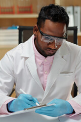 Wall Mural - Laboratory worker filling form with results of tests