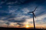 Fototapeta Londyn - A modern aerogenerator (windmill) during a beautiful sunset.
