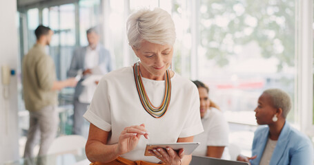 Poster - Business woman, senior and digital tablet for leader planning, thinking and research while in business meeting. Mature woman, internet and search while leading a meeting with creative group in office
