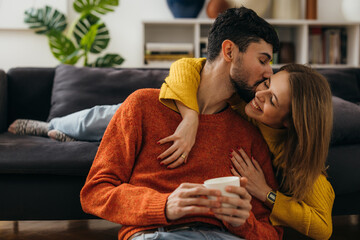 Wall Mural - Loving boyfriend kisses his girlfriend on the cheek