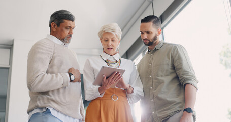 Digital tablet, planning and business people in discussion on corporate project management in the office. Teamwork, collaboration and team analyzing a document or report together on a mobile device.