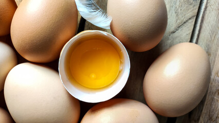 Wall Mural - Many raw and fresh chicken eggs laid on a wooden table.