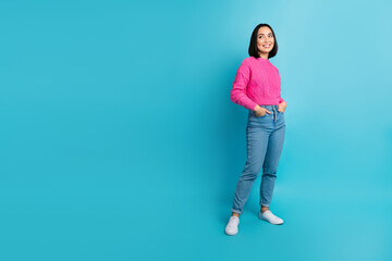 Sticker - Full size photo of cheerful lovely girl put hands pockets look empty space isolated on blue color background