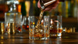 © Lukas Gojda - Close-up of pouring whiskey or rum on the bar, dark toned background