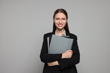 Wall Mural - Portrait of beautiful young teacher on grey background