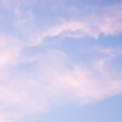Wall Mural - blue sky background with white and pink clouds at sunset