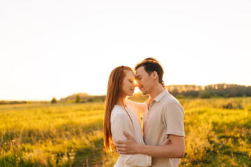 Wall Mural - portrait of loving young couple in relationship hugging and kissing enjoying each other in wonderful
