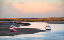 Fishing Boats At Low Tide  On The Sea Creek At Burnham Overy Staithe, Norfolk At Sunrise
