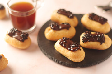 Wall Mural - Traditional French dessert - eclairs with a cup of coffee