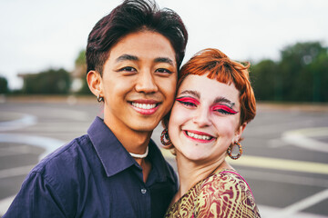 Wall Mural - Young diverse friends having fun outdoor - Focus on gay asian guy wearing make-up