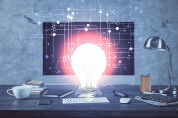 Poster - Computer on desktop in office with bulb icon hologram. Multi exposure. Concept of idea.