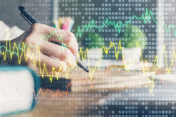 Poster - Financial forex charts displayed on woman's hand taking notes background. Concept of research. Double exposure