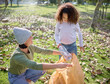 © Nicholas F/peopleimages.com - Trash, volunteer woman and child cleaning garbage, pollution or waste product for community environment support. Plastic bag container, NGO charity and eco friendly kid help with nature park clean up