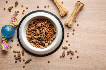 Wall Mural - A bowl with dog food, dog treats and toys on a wooden floor.