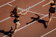 women relay race running for track and field competition
