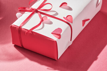 Wall Mural - Gift wrapped in homemade wrapping paper with voluminous hearts.