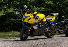 Yellow Sportbike Motorcycle With Helmet On The Parking In Mountains