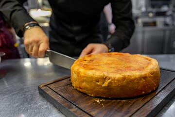 Wall Mural - chef hand cut meat pie on restaurant kitchen