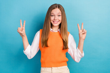 Sticker - Photo of cheerful cool schoolgirl teenager showing v-sign fingers hello everyone showing hello symbol isolated over blue color background