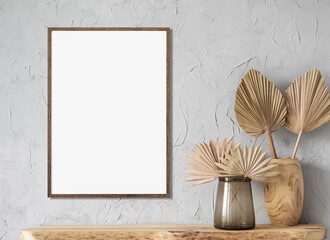 Blank picture frame mockup on wall in modern interior. Artwork template mock up in interior design. View of modern boho style interior with plant in trendy vase. Real photograph