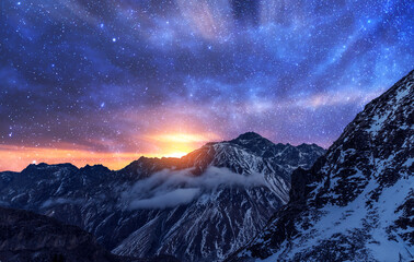 Wall Mural - Fantasy night landscape. Beautiful snow covered mountains in the starry night with milky way galaxy.