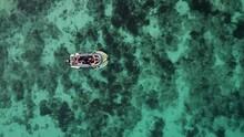 Drone Moves Away From Boat With Two Vacationing Tourists. Two Travelers Vacationing In Philippines, On Island Of Bohol, Sail Sea By Boat. Aerial View Of Beauty Of Endless Surface Of Blue Clear Water.