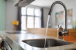 Leinwandbild Motiv Close up shot of modern kitchen faucet with water running from tap