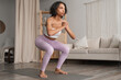 © piksik - Healthy lifestyle concept banner with fit woman doing squats at home. Background with place for text