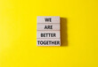 © Natallia - We are stronger together symbol. Wooden blocks with words We are stronger together. Beautiful yellow background. We are stronger together concept. Copy space.