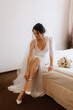 © omelnickiy - preparations for the bride with the dressing of the wedding dress