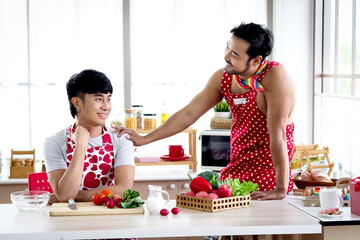 Happy smiling LGBT couple sharing special moment together on Valentine Day, Asian gay male lover having romantic moment during cooking meal at kitchen, celebrate memorable anniversary romantic dating