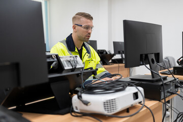 Wall Mural - Male engineer working with desktop computer for training Programmable logic controller in the laboratory. Software engineering concept