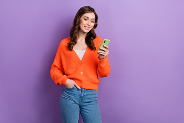 Poster - Photo of positive stunning lady wear orange stylish clothes hold modern telephone promoting device shop isolated on purple color background