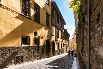 Wall Mural - A picturesque narrow alley leading to the historic medieval old town walled Città Alta district, in the city of Bergamo, Italy, in the Lombardy region.	