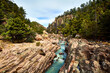 turquoise river of water with sulfur surrounded by forest and cloudy sky in basaseachi chihuahua, sierra tarahumara