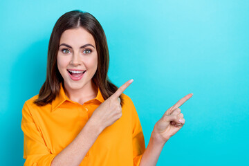 Sticker - Portrait of positive impressed girl with bob hairstyle dressed yellow shirt indicating empty space sale isolated on blue color background