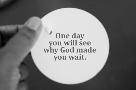 Wall Mural -  - Spiritual inspirational quote - One day you will see why God made  you wait. With person holding white circle tag price paper in hand on black and white background. Spirituality and religious concept.
