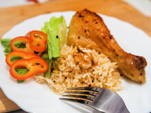 Delicious Chicken Drumstick With Rice And Vegetables On The Plate