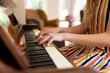 © Wavebreak Media - Midsection of caucasian woman playing piano at home